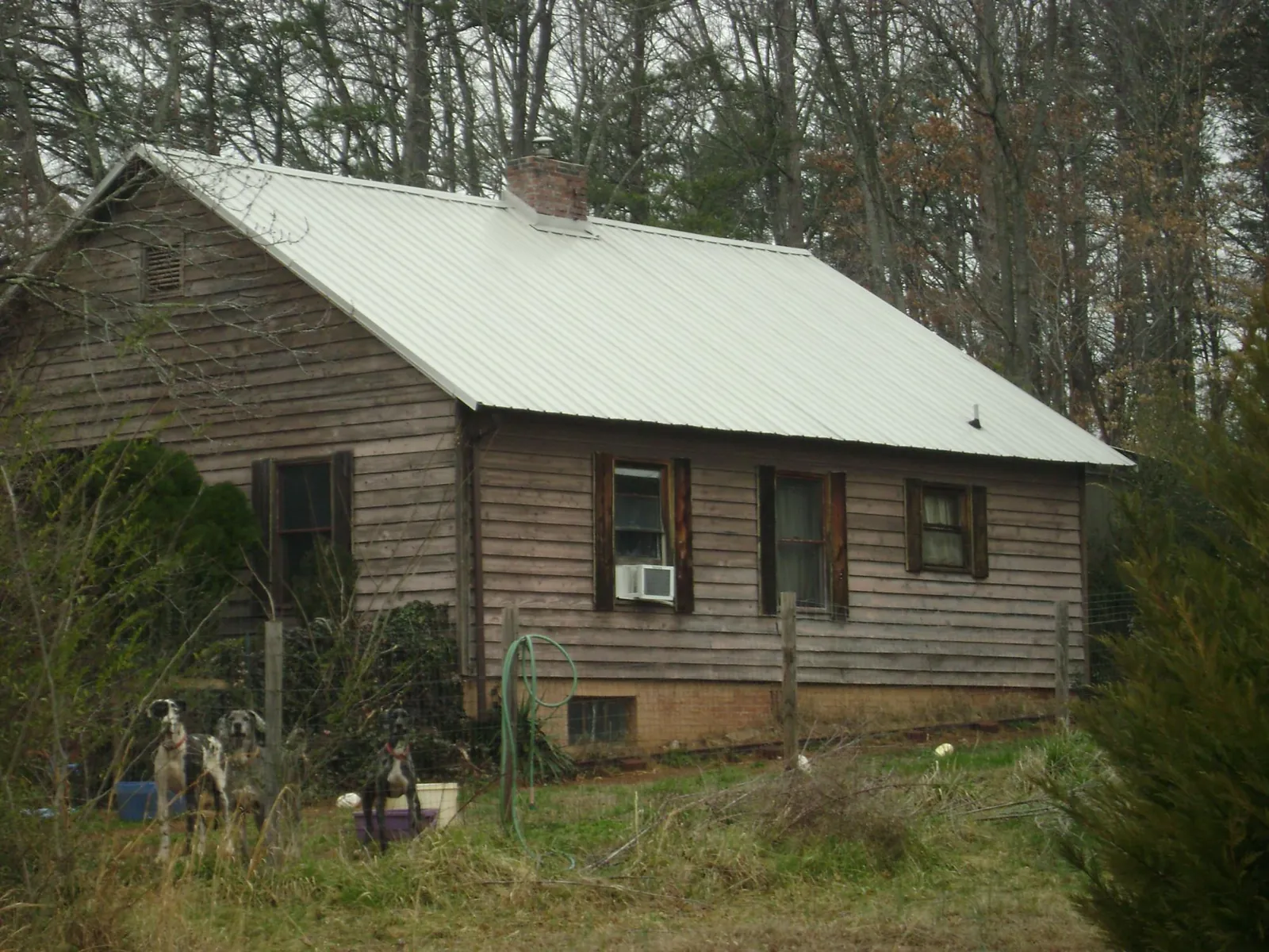 White metal roof on an old wood sided farmhouse, from a Metal Roof Installation job in Hilliards